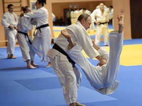 Russian President Vladimir Putin, left, competes against Mikhail Pulyaev, member of Russian national judo team during Russia's national Judo team training session in the resort city of Sochi, Russia, Friday, Jan. 8, 2016.