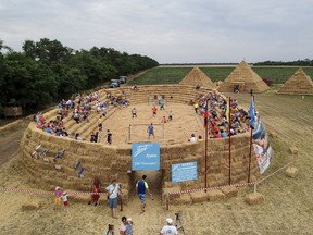 In this photo taken on Saturday, July 22, 2017, shows a view of an arena made of 4,500 straw bales that comes complete with tiered seating and flagpoles in Krasnoye, Stavropol region, South Russia.