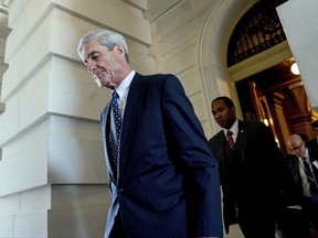 FILE - In this June 21, 2017, file photo, former FBI Director Robert Mueller, the special counsel probing Russian interference in the 2016 election, departs Capitol Hill following a closed door meeting in Washington. A 2001 Justice Department memo warned that no nation, including the United States, was immune from the threat posed by Russian organized crime. The special counsel investigation is bringing attention to Russian efforts to meddle in democratic processes, the type of intelligence gathering that in the past has relied on hired hackers. It's not clear how much the probe by Mueller will center on the criminal underbelly of Moscow, but he's already picked some lawyers with experience confronting organized crime. (AP Photo/Andrew Harnik, File)