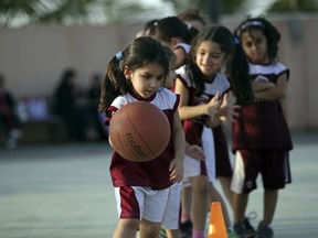 Saudi and expatriate girls practice basketball at a private sports club in Jiddah, Saudi Arabia. Girls will now be able to take P.E., a decision that comes after years of calls by women across the kingdom demanding greater rights and greater access to sports.