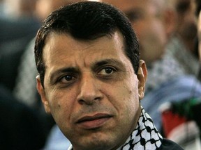 FILE - In this Aug. 4, 2009 file photo, then Fatah leader Mohammed Dahlan listens to a speech during a Fatah conference in the West Bank town of Bethlehem. The exiled Palestinian politician who quietly negotiated a power-sharing deal for Gaza with former arch foe Hamas discussed the details for the first time in an interview, saying he expects the understandings to lead to a swift opening of the blockaded territory's border with Egypt and ease crippling power shortages. (AP Photo/Tara Todras-Whitehill, File)