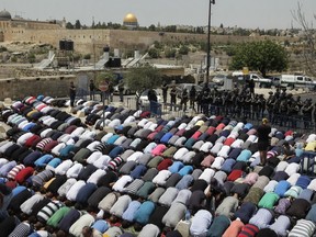 FILE - In this Friday, July 21, 2017 file photo, Palestinians pray outside Jerusalem's Old City. Thousands of Palestinian Muslims have been praying in the streets of Jerusalem every evening _ creating a new, surprisingly effective form of protest in their long conflict with Israel.(AP Photo/Mahmoud Illean, File)