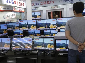 FILE- In this July 6, 2017 file photo, a man watches TV screens in an electronics shop showing a news program's report on North Korea's missile firing in Seoul, South Korea. North Korea fired a ballistic missile Friday night, July 28, which landed in the ocean off Japan, Japanese officials said. (AP Photo/Ahn Young-joon, File)