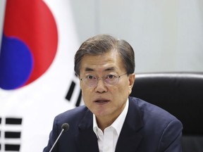 South Korean President Moon Jae-in speaks as he presides over a meeting of the National Security Council at the presidential Blue House in Seoul, South Korea, early Saturday, July 29, 2017. North Korea test-fired on Friday what the U.S. believes was its second intercontinental ballistic missile, which flew longer and higher than its first ICBM launched earlier this month, officials said. (Yonhap via AP)