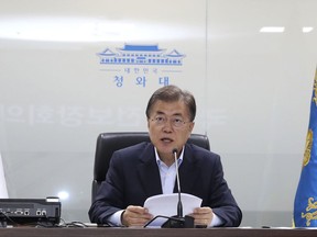 FILE - In this July 4, 2017, file photo, South Korean President Moon Jae-in speaks as he presides over a meeting of the National Security Council at the presidential Blue House in Seoul, South Korea. Moon told U.S. President Donald Trump he's happy to talk about North Korea's ICBM test but after his vacation. It might seem like an oddly timed break for a relatively new president during his country's biggest crisis. (Kim Ju-hyung/Yonhap via AP, File)