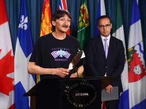 Jerry Natanine, community leader and former mayor of Clyde River, speaks during a press conference on Parliament Hill following a ruling at the Supreme Court of Canada in Ottawa on Wednesday, July 26, 2017. Nader Hasan, Clyde River's legal counsel, look on. THE CANADIAN PRESS/Sean Kilpatrick
