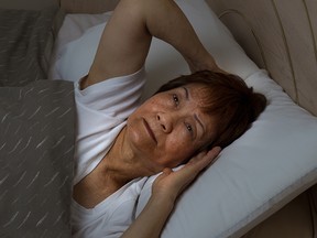 Senior woman cannot sleep at nighttime due to insomnia
