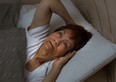 Senior woman cannot sleep at nighttime due to insomnia