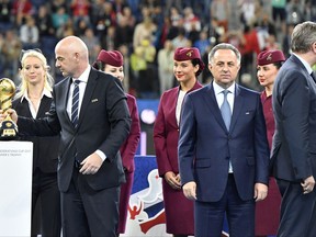 FIFA President Gianni Infantino, Russian Deputy-Prime minister and head of the World Cup 2018 organizing committee Vitaly Mutko and Reinhard Grindel, head of the German soccer federation after Germany won 1-0 in the Confederations Cup final soccer match between Chile and Germany, at the St.Petersburg Stadium, Russia, Sunday July 2, 2017. (AP Photo/Martin Meissner)