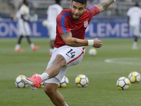 FILE - In this July 1, 2017, file photo, United States' Dom Dwyer warms up before the team's international friendly soccer match against Ghana in East Hartford, Conn. Dwyer and Sydney Leroux were born abroad, came to the United States and dreamed of playing for the national team. Along the way they also found each other. (AP Photo/Jessica Hill, File)