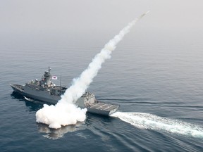 In this photo provided by South Korea Defense Ministry, a South Korean navy ship fires a missile during a drill in South Korea's East Sea, Thursday, July 6, 2017.