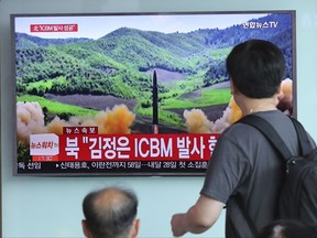 People watch a local TV news showing what was said to be the launch of a Hwasong-14 intercontinental ballistic missile, ICBM, aired by North Korea's KRT, at Seoul Train Station in Seoul, South Korea, Tuesday, July 4, 2017. North Korea claimed to have tested its first intercontinental ballistic missile in a launch Tuesday, a potential game-changing development in its push to militarily challenge Washington -- but a declaration that conflicts with earlier South Korean and U.S. assessments that it had an intermediate range. The part of letters on the bottom "North Korea, Kim Jong Un ICBM Launch." (AP Photo/Lee Jin-man)