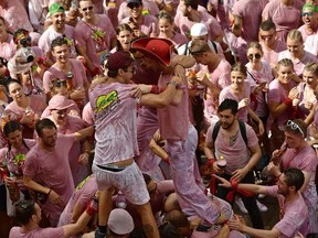 People party during the launching of the 'Chupinazo' rocket, to celebrate the official opening of the 2017 San Fermin Fiestas in Pamplona, Spain, Thursday July 6, 2017. The first of eight days of the running of the bulls along the streets of the old quarter of Pamplona starts Friday. (AP Photo/Alvaro Barrientos)