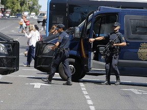 Armed police block a street for security reasons before the Gay Pride demonstration and parade, the climax of the 10-day WorldPride festivities, in Madrid, Spain, Saturday, July 1, 2017. Madrid is celebrating WorldPride 2017, a colorful mixture of vindication for sexual and gender diversity and all-night partying. (AP Photo/Paul White)