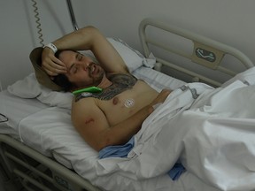 Bill Hillmann, a 35-year-old American from Chicago lies in a hospital bed after being gored at the San Fermin bull running Festival, in Pamplona, northern Spain, Saturday, July 8, 2017.