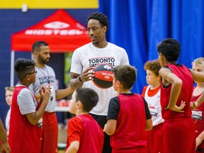 The Toronto Raptors' DeMar DeRozan spends some time with young basketball players at the Raptors Basketball Academy held at Humber College in Toronto, Ont. on Tuesday July 25, 2017.