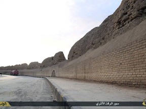 This image posted online on March 22, 2015, by the Islamic State group, shows the Old City wall of Raqqa. The wall built around Rafiqah, the 8th century garrison town built next to Raqqa, was breached by US-backed Syrian fighters on Monday, July 3, 2017. US officials described the breach as a "key milestone" in the battle against the Islamic State militants, who had taken Raqqa as their de-facto capital since 2014. The US-led coalition said they struck "two small portions" in the wall but the rest of the 2,500 meters long wall remains intact. (Islamic State media via AP)