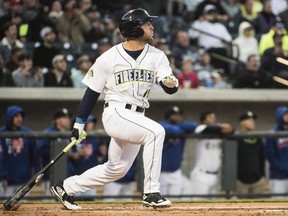 FILE - In this April 6, 2017, file photo, Columbia Fireflies' Tim Tebow watches his home run in his first at bat on the opening day during a Class A minor league baseball game against the Augusta GreenJackets in Columbia, S.C. Tebow hit the ball well in his first week with the St. Lucie Mets, though his team dropped five of his first six games there. Tebow batted .429 in his first week in the Florida State League, where as expected he's getting plenty of attention. (AP Photo/Sean Rayford, File)