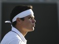 Milos Raonic reacts after a point against Alexander Zverev at Wimbledon on July 10.