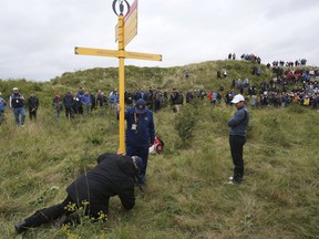 Northern Ireland's Rory McIlroy waits for a sign to be moved so he can play his shot in the rough on the 15th hole during the second round of the British Open Golf Championship at Royal Birkdale,, Southport, Friday July 21, 2017. (Richard Sellers/PA via AP)