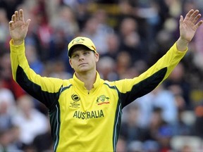 FILE - In this June 10, 2017 file photo, Australia captain Steve Smith gestures during the ICC Champions Trophy match between England and Australia at Edgbaston in Birmingham, England. The chairman of Cricket Australia has heavily criticized the country's top players for their stance in a two-week-long pay dispute, and accused the Australian Cricketers' Association of a "reckless strategy that can only damage the game, in an opinion piece in The Australian newspaper on Thursday, July 13, 2017. (AP Photo/Rui Vieira, File)