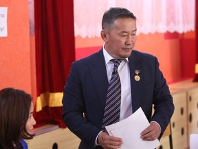 FILE - In this July 7, 2017 file photo released by Xinhua News Agency, Mongolian Democratic Party presidential candidate Khaltmaa Battulga votes at a polling station during a run-off election for the country's presidency in Ulaanbaatar, Mongolia. Preliminary results early Saturday, July 8 after most of the polling stations were counted showed Battulga of the Democratic Party was leading with 50.6 percent of the vote. (Asigang/Xinhua via AP, File)