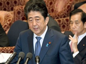 Japanese Prime Minister Shinzo Abe speaks during a session of the House of Representatives Budget Committee in Tokyo Monday, July 24, 2017. Abe once again denied that he misused his influence to help a friend in a growing favoritism scandal Monday as support ratings for his scandal-laden Cabinet hit new lows. Regular parliamentary session ended late June and holding one during its summer recess is extremely rare. (Yoshinobu Shimizu/Kyodo News)