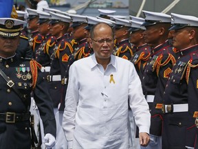 FILE - In this June 1, 2016 file photo, former Philippine President Benigno Aquino III reviews the troops during the commissioning ceremony for the new Philippine Navy Strategic Sealift Vessel BRP Tarlac and three other vessels at the South Harbor in Manila. The anti-graft prosecutor in the Philippines has ordered the filing of criminal charges against former President Benigno Aquino III for his alleged liability in a 2015 clash with Muslim rebels that killed 44 police.(AP Photo/Bullit Marquez, File)