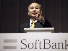 FILE - In this Nov. 4, 2014 file photo, SoftBank founder and Chief Executive Officer Masayoshi Son speaks during a news conference in Tokyo. Softbank and China's top ride-hailing firm Didi Chuxing are pouring $2 billion into the latest round of financing by cash-hungry Southeast Asian taxi app Grab.  Grab said Monday, July 24, 2017, that it expects another $500 million will come from other existing and new investors. Its last announced cash injection was in September when it raised $750 million led by Softbank, whose chief executive Son is Japan's richest person and a self-styled tech visionary. (AP Photo/Eugene Hoshiko, File)