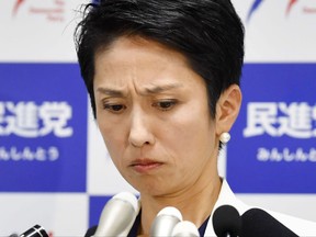Japan's opposition Democratic Party leader Renho Murata grimaces during a press conference at her party's headquarters in Tokyo Tuesday, July 18, 2017. Renho, born to a Taiwanese father and Japanese mother, said she released the documents to show she had renounced her earlier Taiwanese citizenship and she now only has Japanese nationality. Public doubts over her unclear status have been blamed for her party's recent election loss in a country where there is strong pressure for conformity. Japanese characters in the background read: "Democratic Party." (Nobuki Ito)