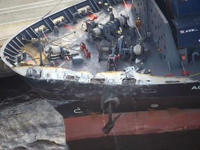 FILE - In this June 17, 2017, file photo, the container ship ACX Crystal with its left bow dented and scraped after colliding with the USS Fitzgerald off Japan earlier in the day, is berthed at the Oi Container Terminal in Tokyo. Japanese authorities said Monday, July 24, 2017, they're wrapping up their investigation into the collision of the freighter and the USS Fitzgerald without any verdict into what caused the accident, which left seven Navy sailors dead. The ACX Crystal and most of its crew were allowed to leave Japan for Thailand on Sunday, July 23 after repairs were finished. Coast guard officials said they don't expect charges to be filed. (Hitoshi Takano/Kyodo News via AP, File)