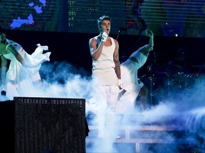 In this Sept. 29, 2013, file photo, Justin Bieber performs on a stage during his world tour concert in Beijing.
