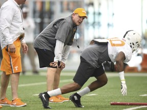 FILE - In this March 31, 2016, file photo, Tennessee defensive coordinator Bob Shoop, center, coaches a player during spring football practice at Anderson Training Center  in Knoxville, Tenn. Shoop has encountered plenty of adversity since coming over from Penn State last year. His defense was decimated by injuries and struggled to slow down anyone late last season. Now that he's getting ready to begin his second season with the Volunteers, his former employer has sued him for breach of contract. (Adam Lau/Knoxville News Sentinel via AP, File)