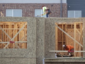 In this July 12, 2017, photo, construction workers build a residential complex in Nashville, Tenn. On Friday, July 28, 2017, the Commerce Department issues an economic report on how the U.S. economy is performing. (AP Photo/Mark Humphrey)