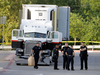 San Antonio police investigate the scene Sunday, July 23, 2017, where eight people were found dead in a tractor-trailer loaded with at least 30 others outside a Walmart store in stifling summer heat in what police are calling a horrific human trafficking case. Two others died later in hospital.