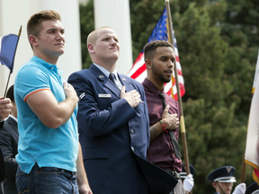 Oregon National Guardsman Alek Skarlatos, left, U.S. Airman Spencer Stone, center, and Anthony Sadler attend a parade held to honour the three Americans who stopped a gunman on a Paris-bound passenger train.