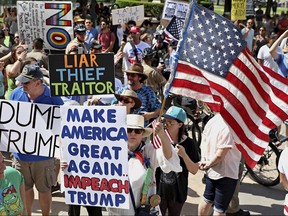 Anti-Trump supporters rally at the Texas State Capitol on Sunday, July 2, 2017, during an impeachment march  in Austin, Texas by anti-Trump supporters in hopes to gain attention and impeach Trump. (Joshua Guerra /Austin American-Statesman via AP)