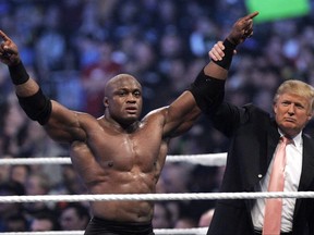 FILE - In this Sunday, April 1, 2007, file photo, Donald Trump raises the arm of wrestler Bobby Lashley after he defeated Umaga at Wrestlemania 23 at Ford Field in Detroit. Trump body-slammed and then shaved the head of WWE boss Vince McMahon after what was known as the "Battle of the Billionaires." Wrestling aficionados say the president has, consciously or not, long borrowed the time-tested tactics of the game to cultivate the ultimate antihero character, a figure who wins at all costs, incites outrage and follows nobody's rules but his own. (AP Photo/Carlos Osorio, File)
