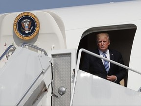 President Donald Trump arrives on Air Force One at Morristown Municipal Airport, in Morristown, N.J., Friday, June 30, 2017, en route to Trump National Golf Club in Bedminster, N.J.. The president is traveling with first lady Melania Trump and their son Barron Trump. (AP Photo/Carolyn Kaster)