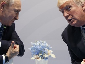 In this July 7, 2017, file photo, U.S. President Donald Trump, right, meets with Russian President Vladimir Putin at the G20 Summit in Hamburg, Germany.