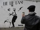 A mural by English street artist Bambi depicting British Prime Minister Theresa May dancing with Trump in London. 