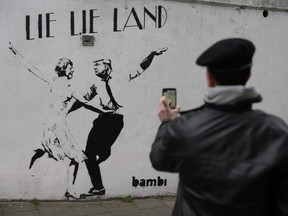 A mural by English street artist Bambi depicting British Prime Minister Theresa May dancing with Trump in London.