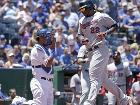 Minnesota Twins' Miguel Sano (22) crosses the plate in front of Kansas City Royals catcher Salvador Perez after hitting a solo home run during the third inning of the first baseball game of a doubleheader Saturday, July 1, 2017, in Kansas City, Mo. (AP Photo/Charlie Riedel)