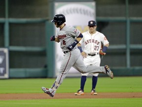 Minnesota Twins' Brian Dozier (2) runs past Houston Astros' Jose Altuve after hitting a home run during the first inning of a baseball game Saturday, July 15, 2017, in Houston. (AP Photo/David J. Phillip)