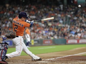 Houston Astros' Alex Bregman hits an RBI double to score Yuli Gurriel as Minnesota Twins catcher Jason Castro watches during the second inning of a baseball game Friday, July 14, 2017, in Houston. (AP Photo/David J. Phillip)