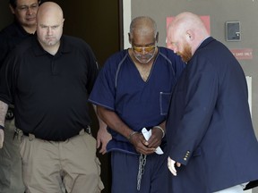 James Mathew Bradley Jr., 60, of Clearwater, Florida, center, is escorted out of the federal courthouse following a hearing, Monday, July 24, 2017, in San Antonio. Bradley was arrested in connection with the deaths of multiple people packed into a broiling tractor-trailer. (AP Photo/Eric Gay)