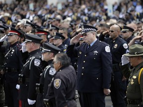 Visiting officers attend services for San Antonio police officer Miguel Moreno, Friday, July 7, 2017, in San Antonio. Moreno died of wounds suffered when he and his partner were shot by a man they intended to question about a vehicle break-in last week. (AP Photo/Eric Gay)