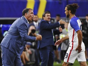 United States head coach Bruce Arena calls out to his team as United States' Graham Zusi (19) steps off the field during a CONCACAF Gold Cup semifinal soccer match in Arlington, Texas, Saturday, July 22, 2017. (AP Photo/Jeffrey McWhorter)