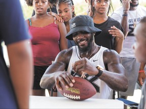 Dez Bryant signs a football at Kit McConnico Park in Lufkin, Texas, Thursday, July 20, 2017. The Dallas Cowboys' wide receiver returned to his East Texas hometown to thank supporters with a free barbecue that drew several thousand fans to the park.  (Cara Campbell/The Lufkin News via AP)/The Daily News via AP)