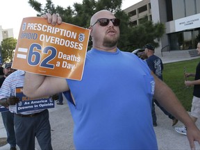 Clint Powell, of Keller, Texas, marches with other Teamsters as they protest outside the McKesson Corp. shareholders meeting in Irving, Texas, Wednesday, July 26, 2017. McKesson Corp. is the largest U.S. distributor of prescription drugs. (AP Photo/LM Otero)